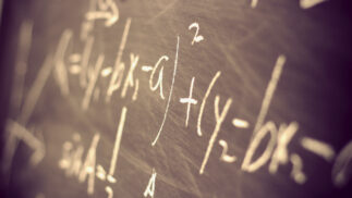 Chalkboard with mathematical equations written on it.