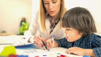 Psychologist and child working on a problem.