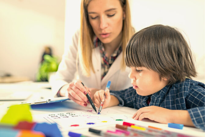 Psychologist and child working on a problem.