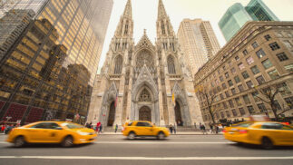 St. Patrick's Cathedral in New York City with taxis in front on the street.