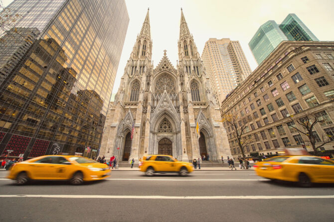 St. Patrick's Cathedral in New York City with taxis in front on the street.