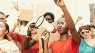 Group of young people leading a demonstration for social justice.