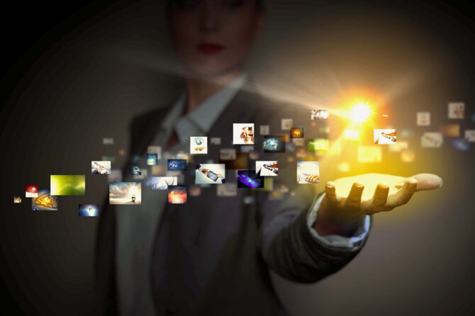 Computer application icons in human hand.