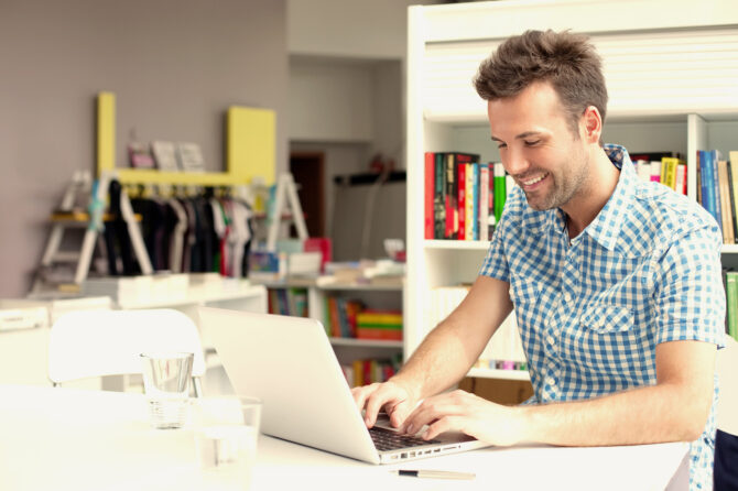 Person working on a notebook computer in an informal office.