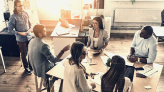 racially and culturally diverse team working on a project in an informal office.