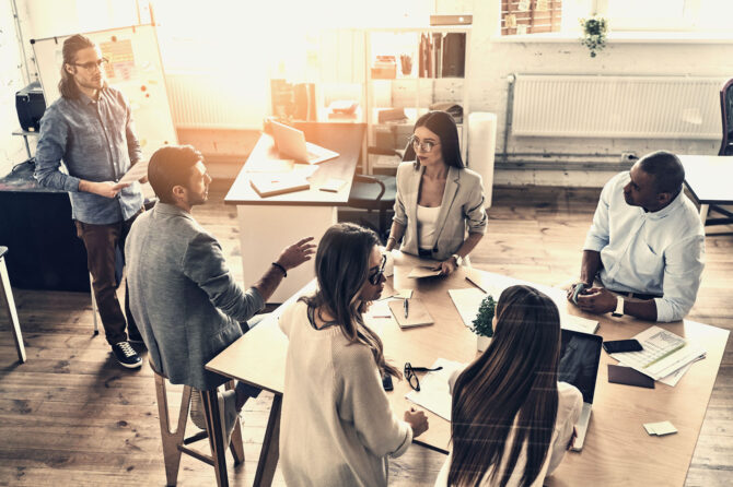 racially and culturally diverse team working on a project in an informal office.