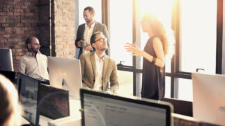 Team of four people in business discussions in an office.