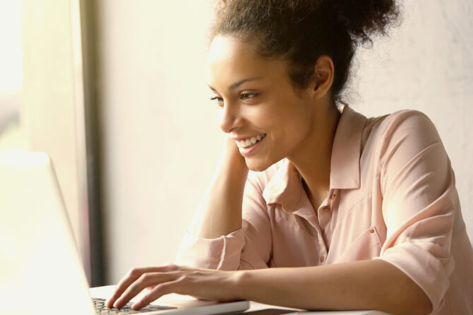 Young writer creating content on a notebook computer.