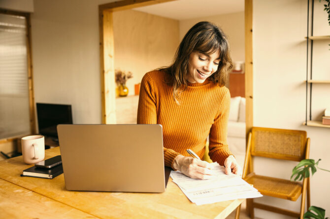 A woman working at a laptop.