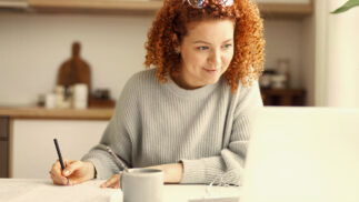 A woman studying in front of a laptop.