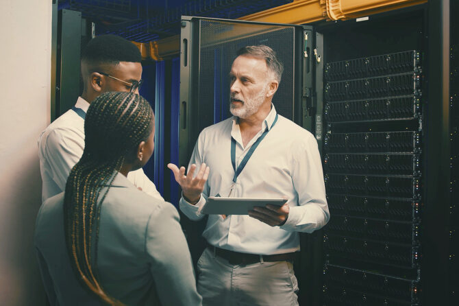 Cybersecurity professionals in a server room.
